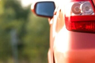 Derry Car accident lawyer features photo of a car pulled over to the side of a new hampshire road after an accident with an emergency caution sign/triangle on the ground next to the car